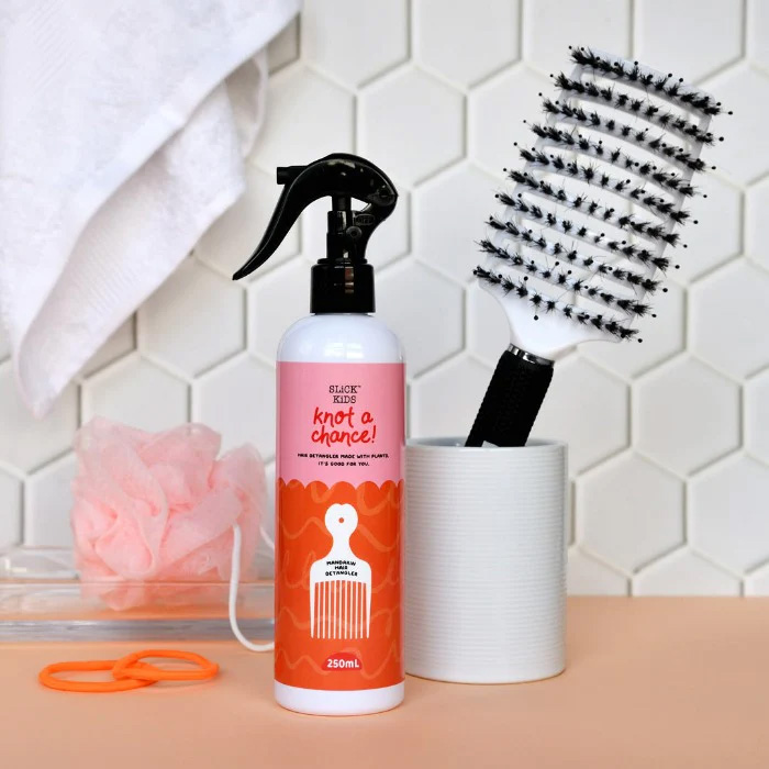 white detangler hair brush and detangler spray