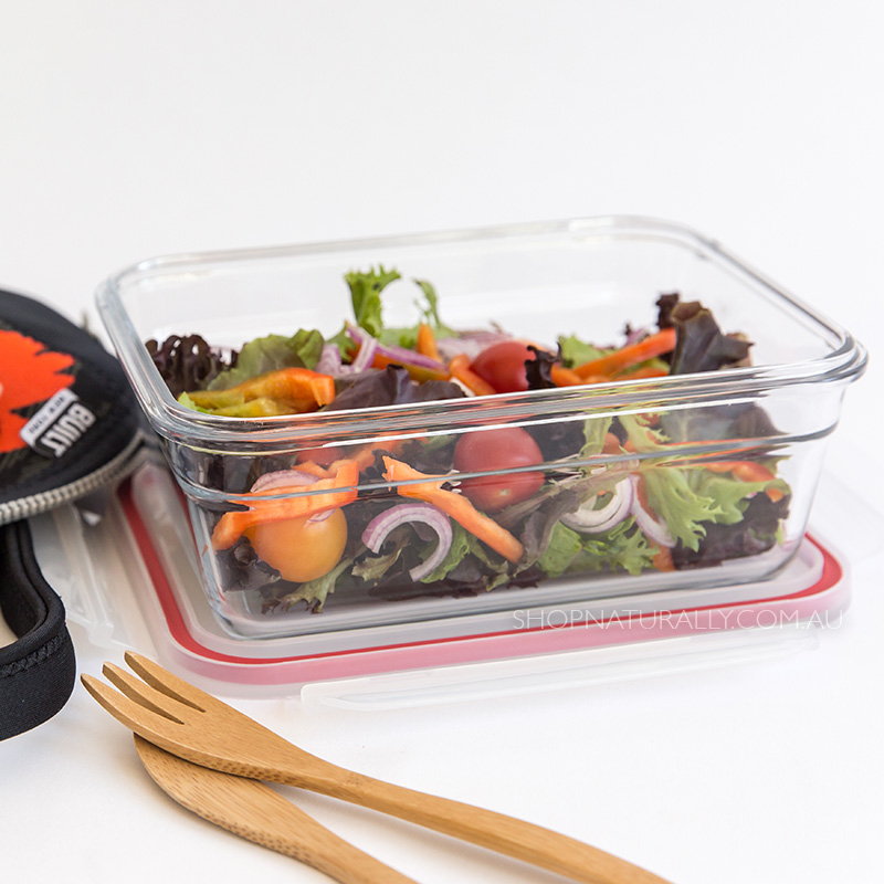 glass lunch box holding a salad